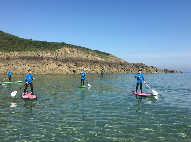 Ride a stand up paddle during a lesson.
