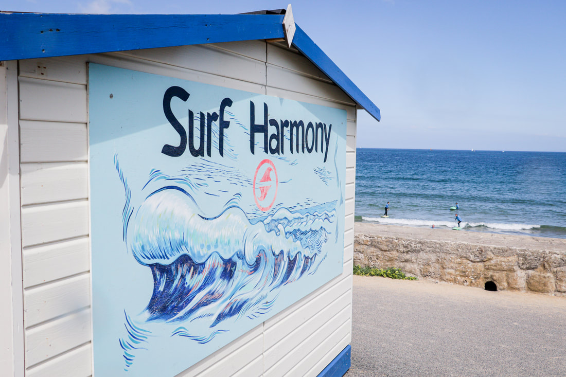 Surf Harmony School at Longchamp Beach, next to the waves.
